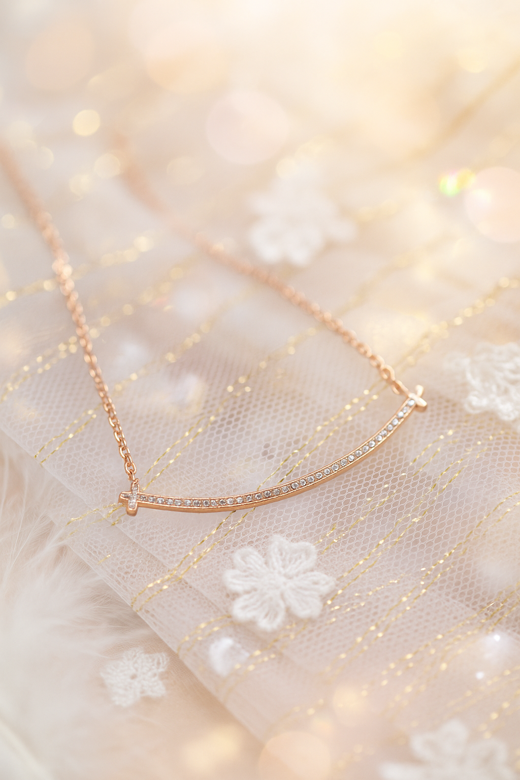 Curved bar covered in rhinestones, rose-gold chain