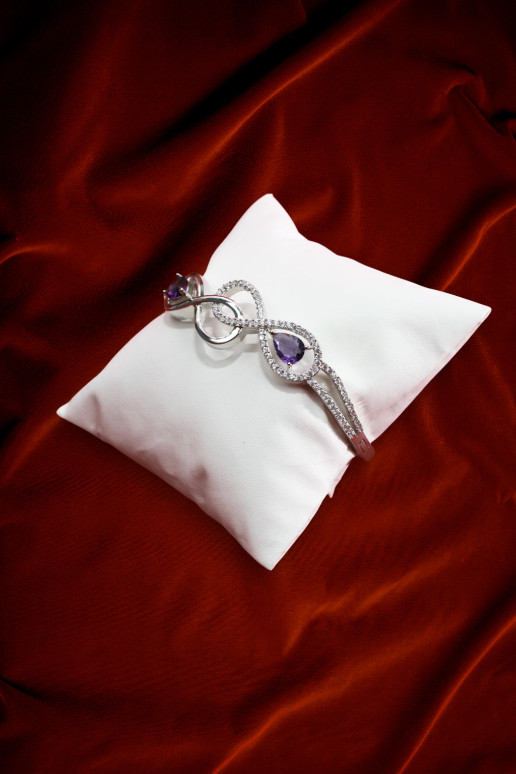 Infinity-Inspired Silver Bracelet with Dual Purple Stones