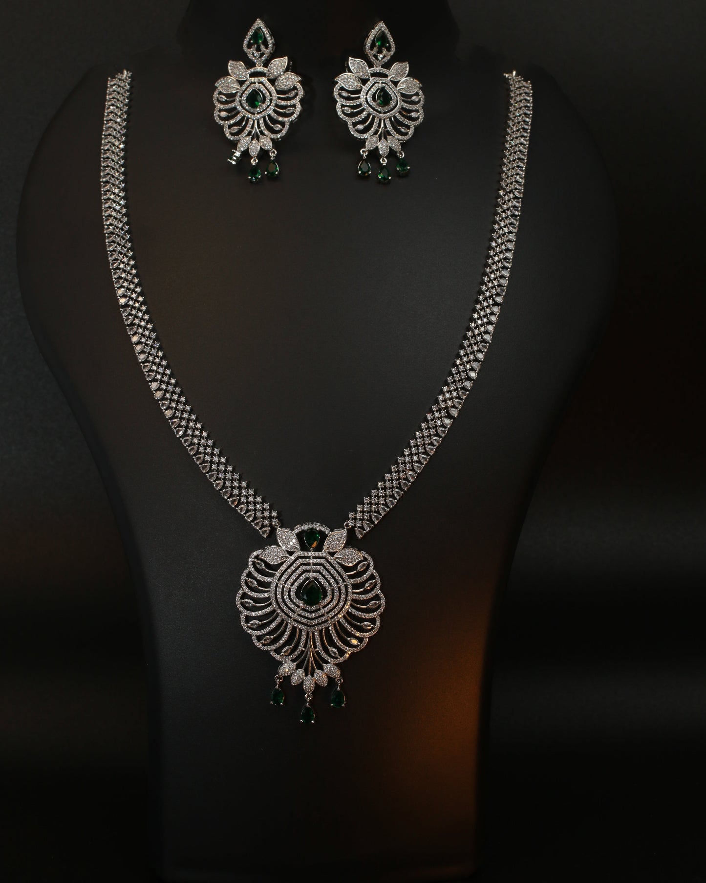 Decorative silver jewelry set on a dark background