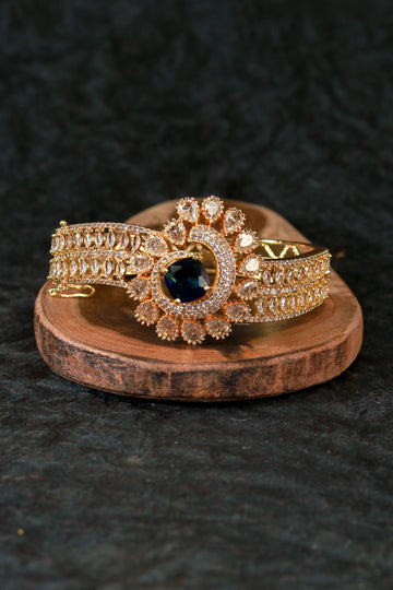Gold Bracelet with Peacock Design and Blue Stone