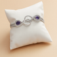 Infinity-Inspired Silver Bracelet with Dual Purple Stones