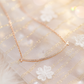 Curved bar covered in rhinestones, rose-gold chain
