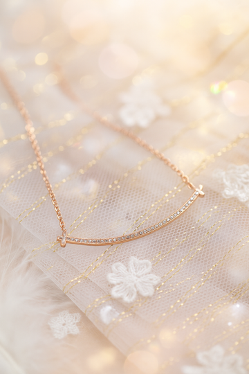 Curved bar covered in rhinestones, rose-gold chain