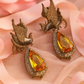 Silver-Tone Phoenix Earrings with Yellow Drop