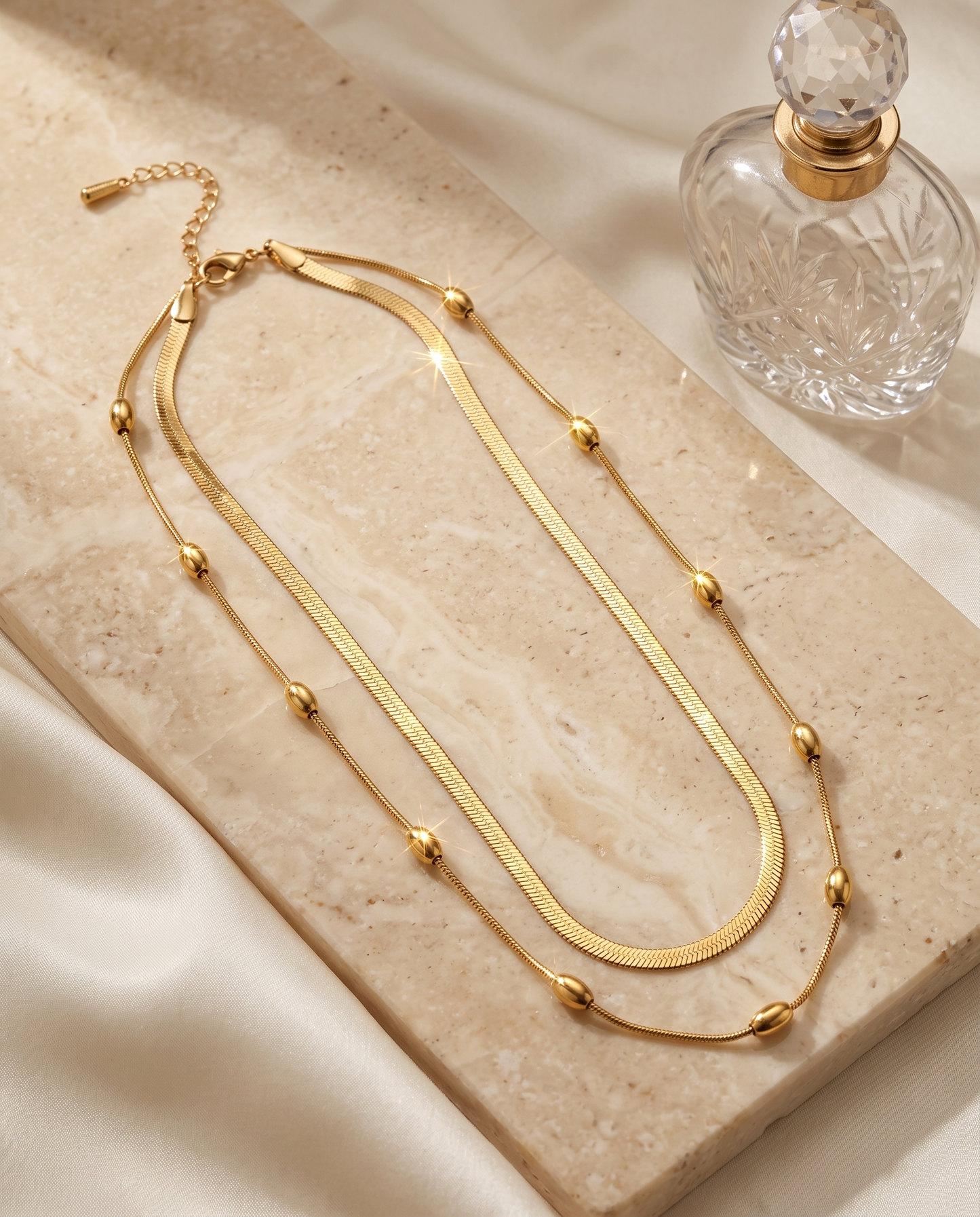 Layered snake chain necklace and earrings set, gold plated, waterproof – styled on jewelry stand