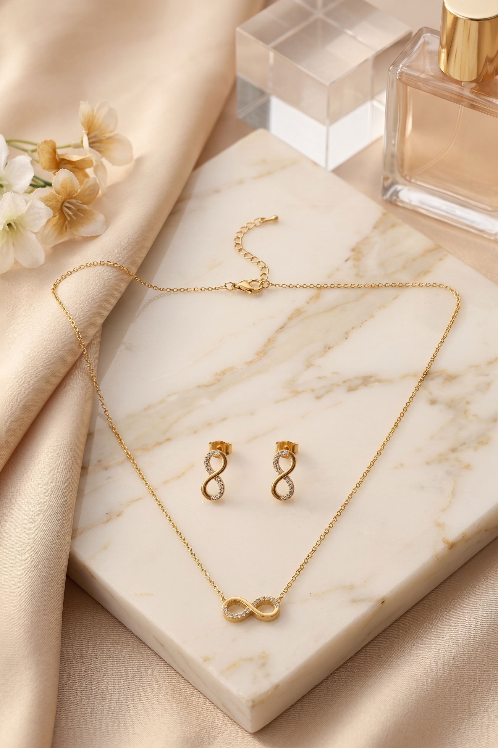 Infinity lucky 8 necklace and matching earrings set, 18K gold plated – styled on jewelry stand