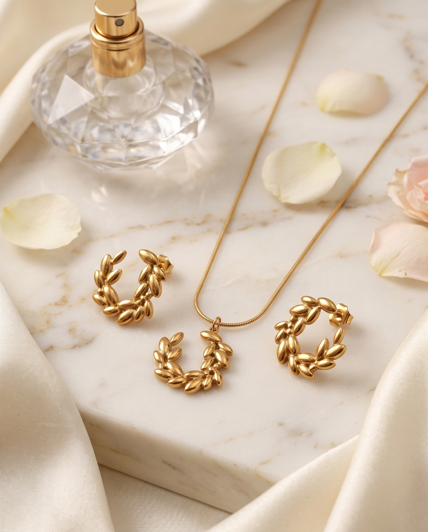 Laurel wreath pendant necklace and matching stud earrings set, gold plated – styled on jewelry stand
