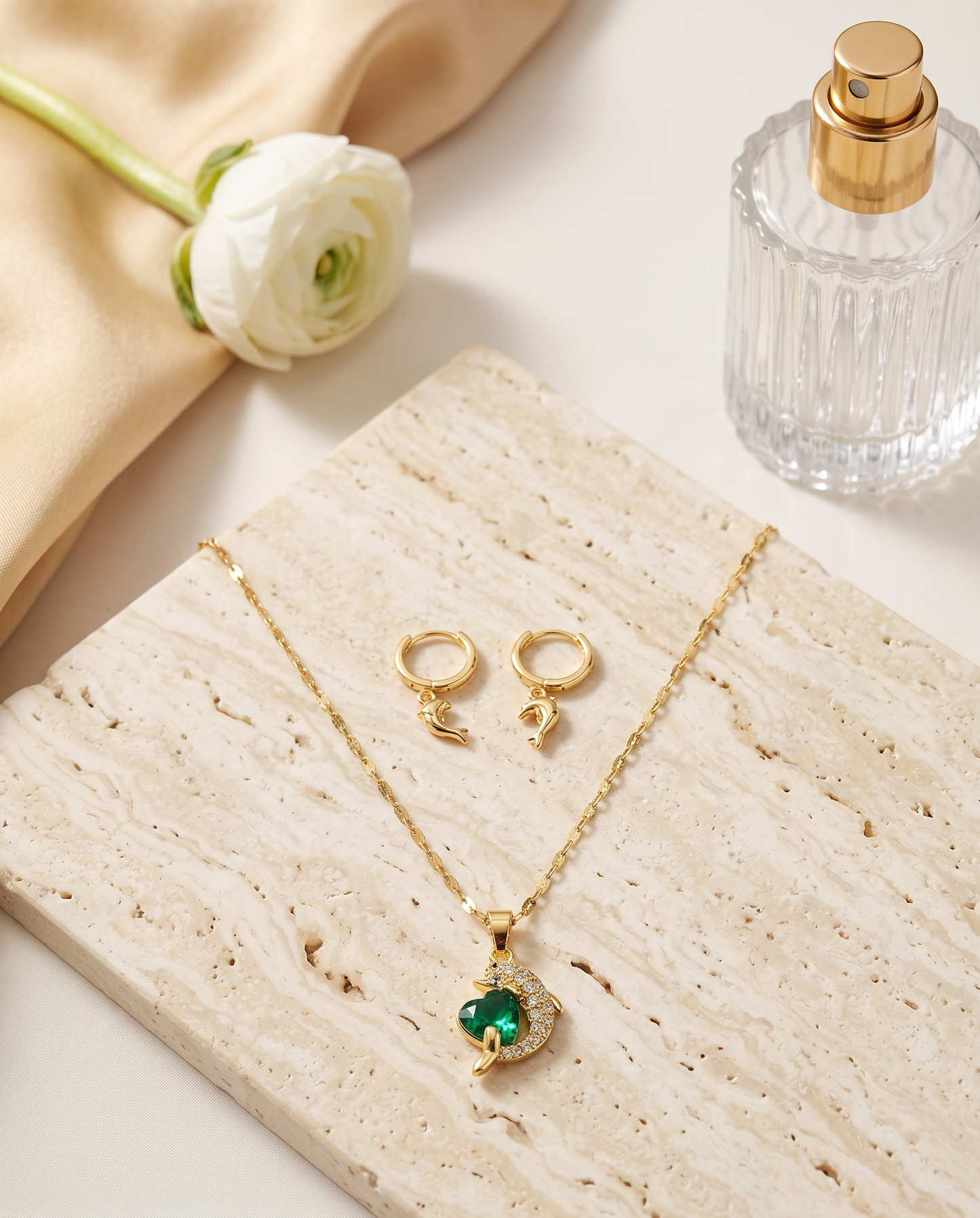Dolphin heart zircon pendant necklace and matching earrings set, gold plated – styled on jewelry stand