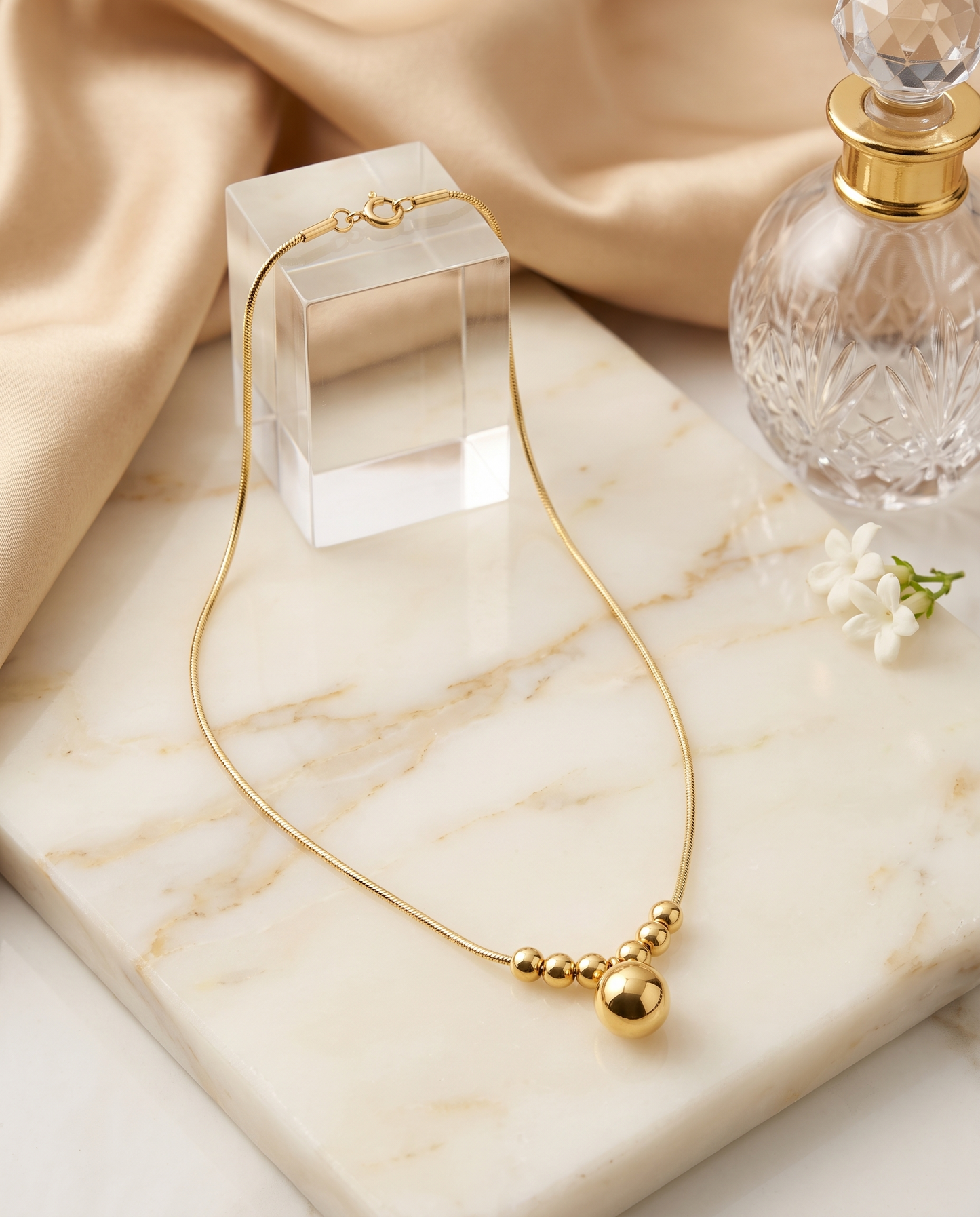Geometric pendant snake chain necklace, 18K gold plated – styled on jewelry stand