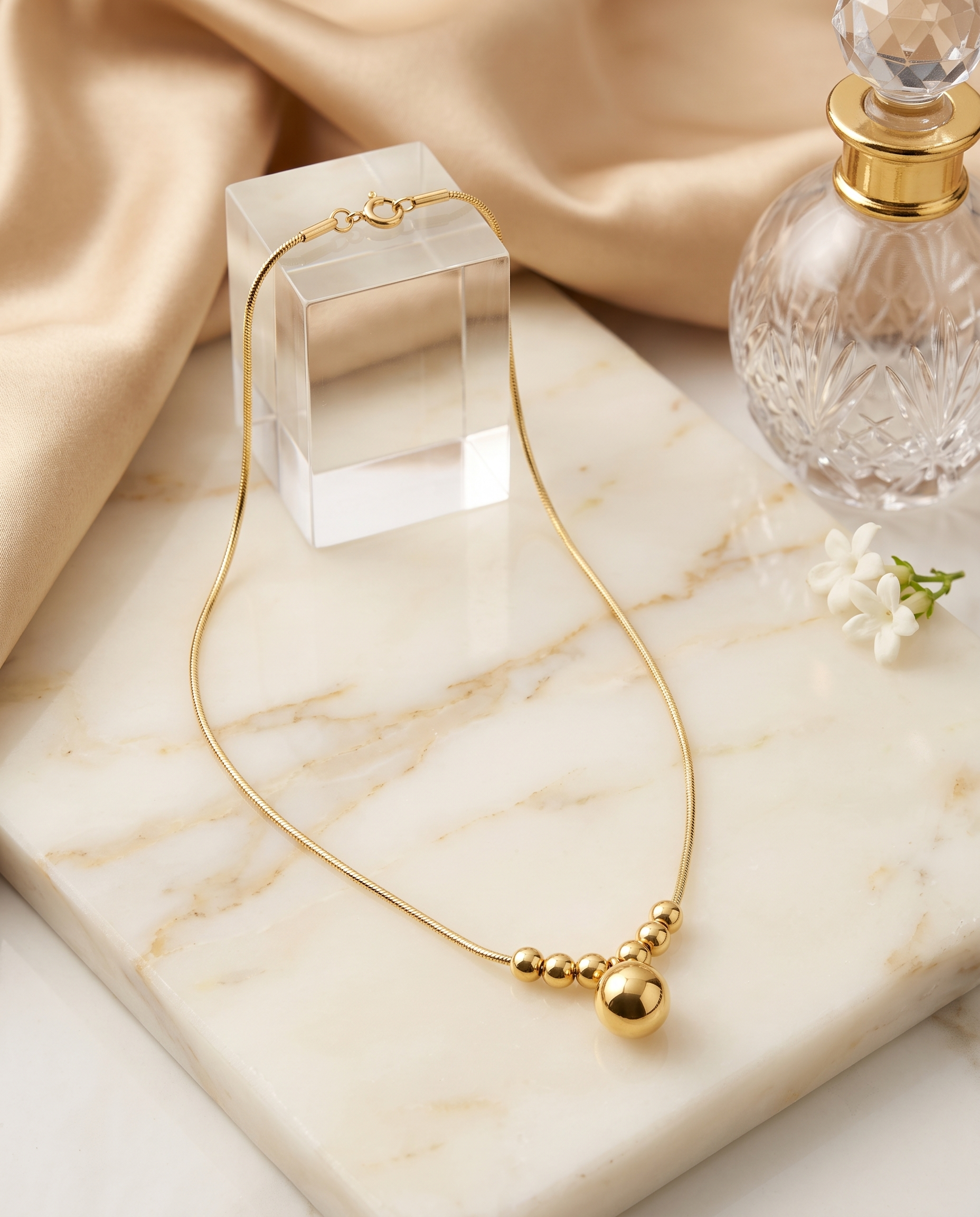 Geometric pendant snake chain necklace, 18K gold plated – styled on jewelry stand