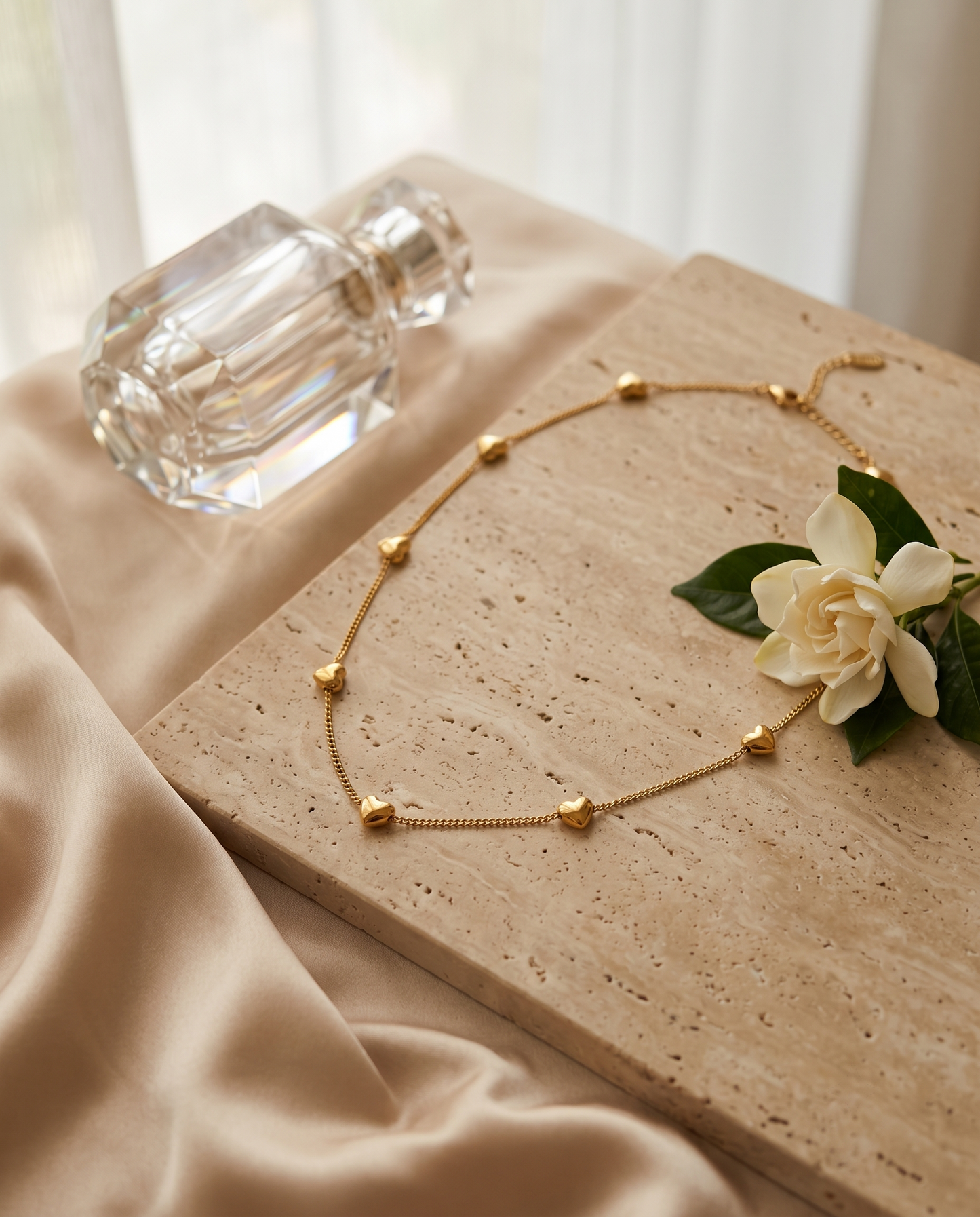 Heart station chain necklace, gold plated titanium steel – styled on jewelry stand
