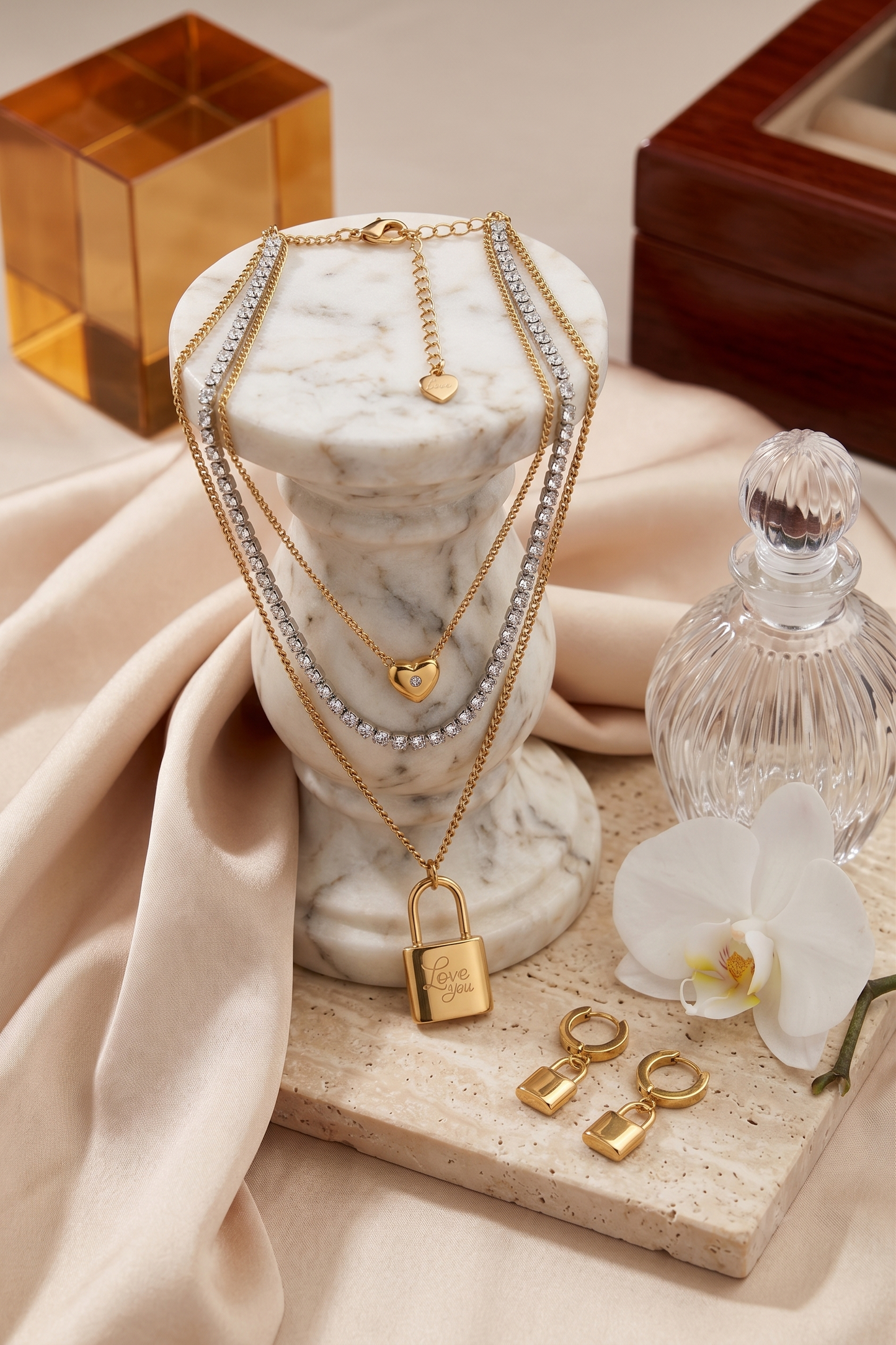 Love lock layered necklace and matching lock drop earrings set, 18K gold plated – styled on jewelry stand