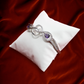 Infinity-Inspired Silver Bracelet with Dual Purple Stones