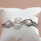 Infinity Curve Silver Bracelet with Soft Pink Stones