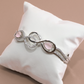 Infinity Curve Silver Bracelet with Soft Pink Stones