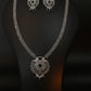 Decorative silver jewelry set on a dark background