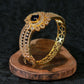 Gold Bracelet with Peacock Design and Blue Stone
