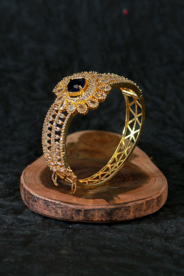 Gold Bracelet with Peacock Design and Blue Stone